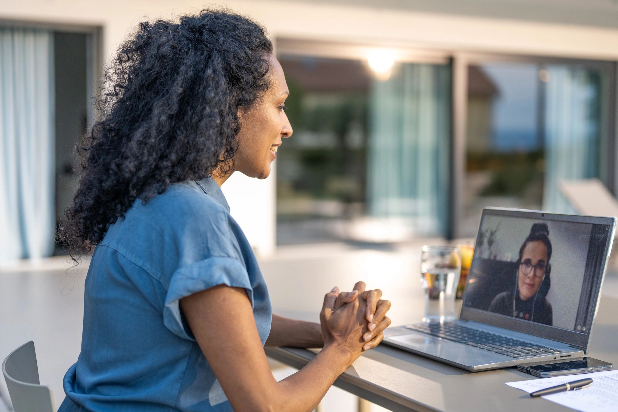 Person working on a laptop during a video call