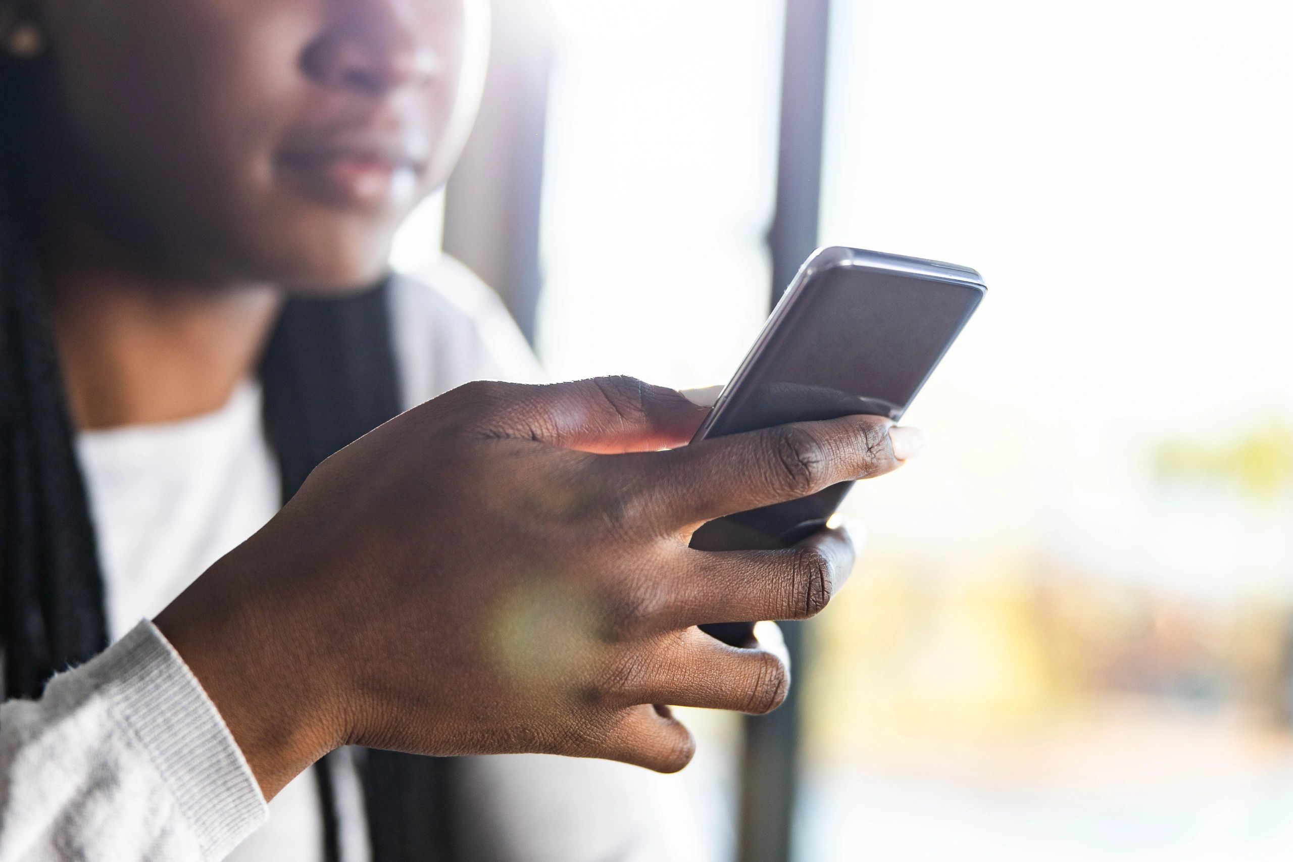 Reader using a phone at home