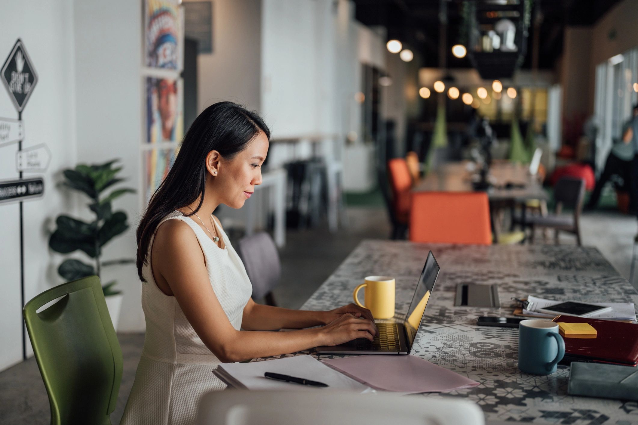 Author working on a laptop in a modern workspace
