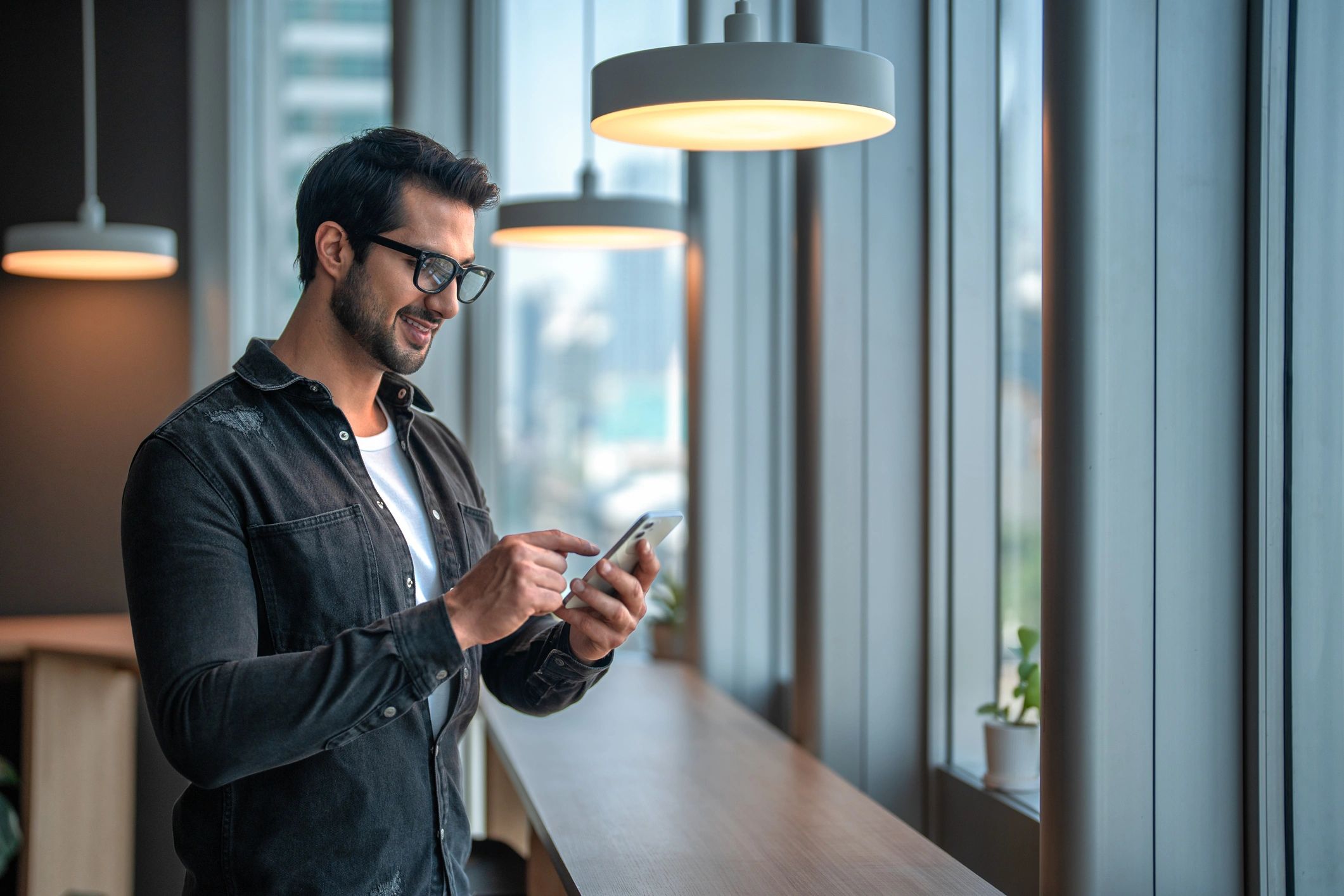 Person using a smartphone in an office