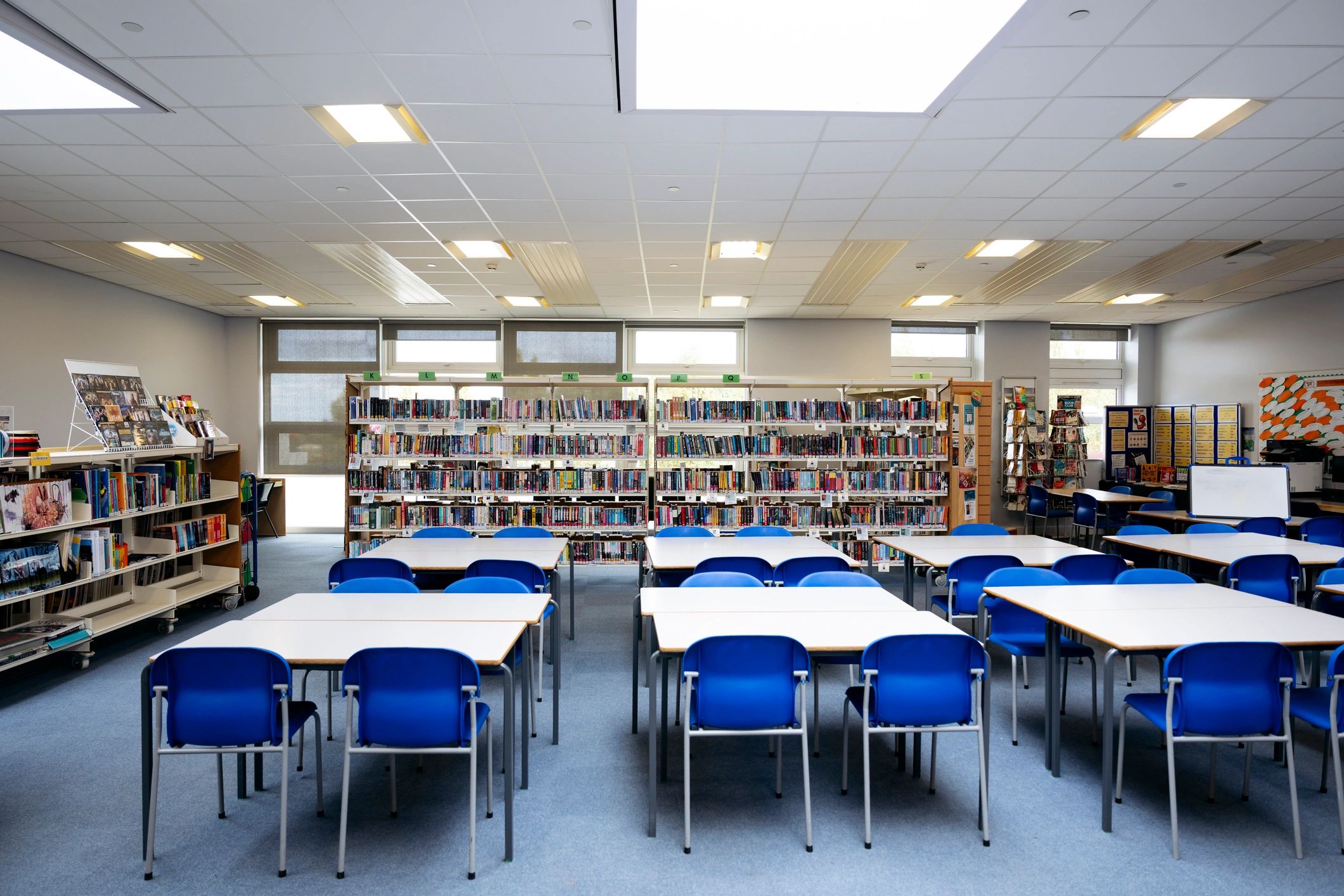 Library interior with bookshelves and study tables